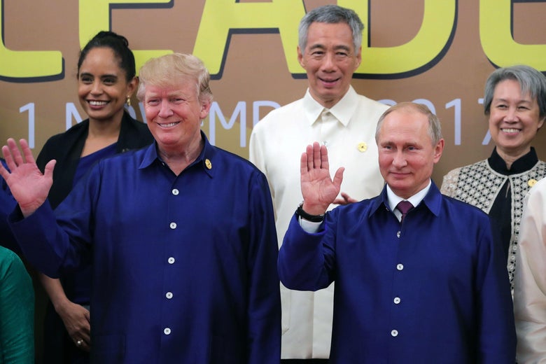 US President Donald Trump (L) and Russia's President Vladimir Putin (R) wave as they pose for a group photo ahead of the Asia-Pacific Economic Cooperation (APEC) Summit leaders gala dinner in the central Vietnamese city of Danang on November 10, 2017. / AFP PHOTO / SPUTNIK / Mikhail KLIMENTYEV (Photo credit should read MIKHAIL KLIMENTYEV/AFP/Getty Images)